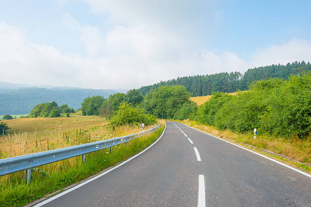 istock Road through a hilly landscape in summer 585051102