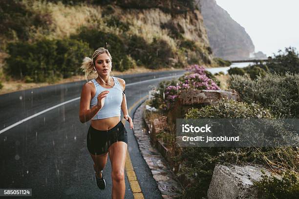 Fitness Woman Running On Highway Stock Photo - Download Image Now - Running, Women, One Woman Only