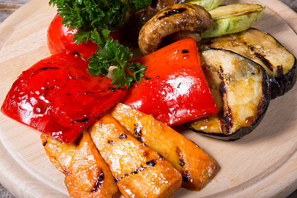 istock Grilled vegetables on wooden board 585052974