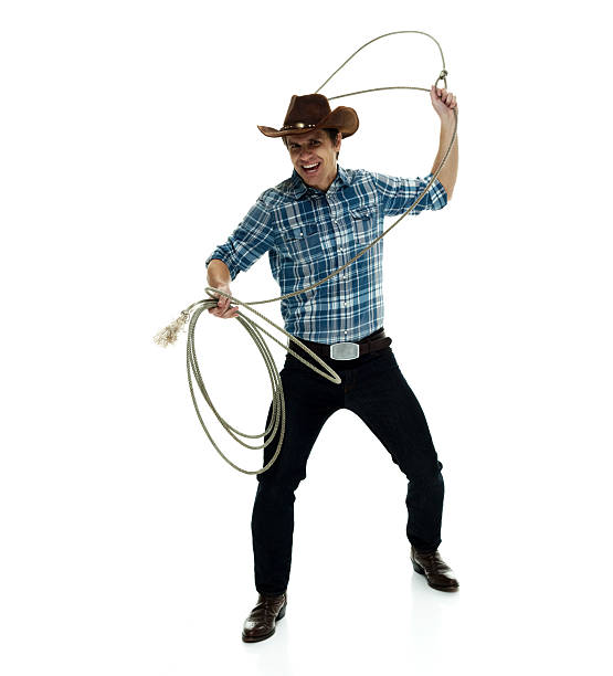 istock Smiling cowboy lassoing 585053452