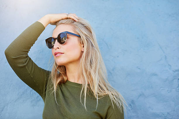 istock Young blonde in sunglasses looking away 585054498