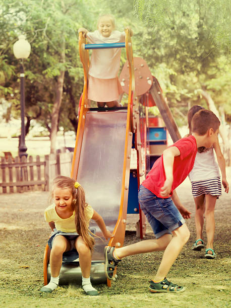 istock children having fun on slide at playground 585054506