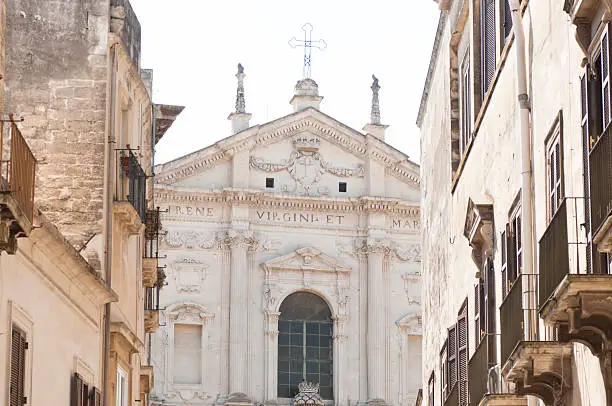 Glimpse of a way of the facade of the baroque church of St. Irene in Lecce