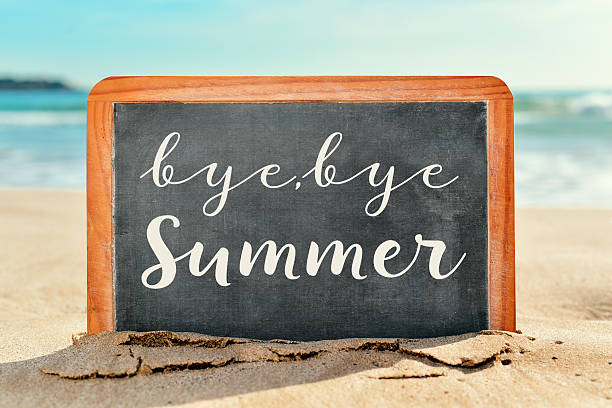 istock text bye, bye summer in a chalkboard on the beach 585055146