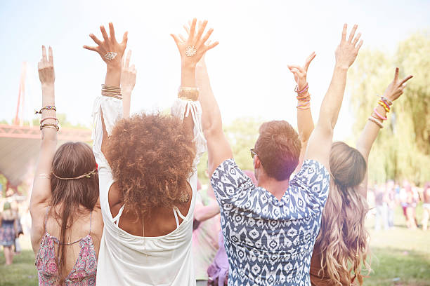 istock Rear view of friends with hands up 585055938