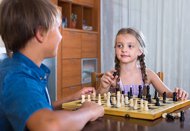 istock children at chess board indoors 585055964