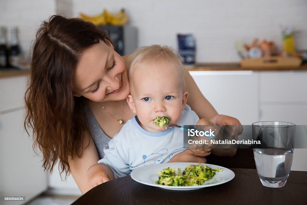 Mother and child eating together Mother with her child eating together and have a fun Baby - Human Age Stock Photo