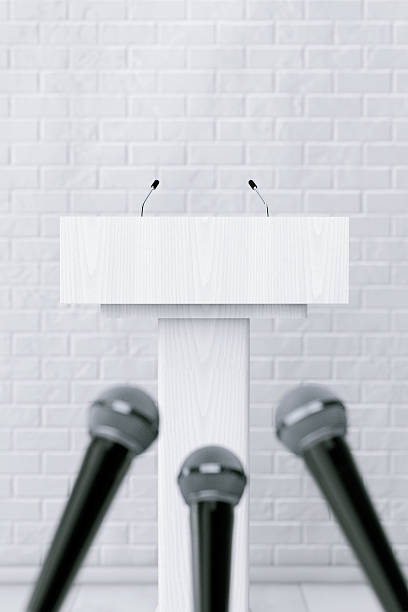 istock White Podium Tribune Rostrum Stand with Microphones. 3d Renderin 585056620
