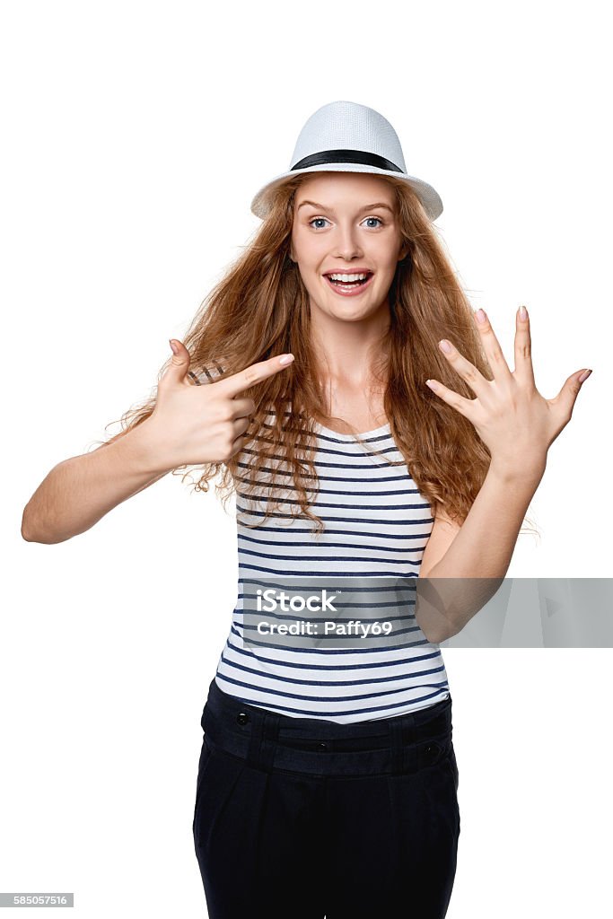 Hand counting - seven fingers Hand counting. Happy excited summer woman in straw fedora hat showing seven fingers. Girl showing five fingers and pointing at it with other hand. Adult Stock Photo