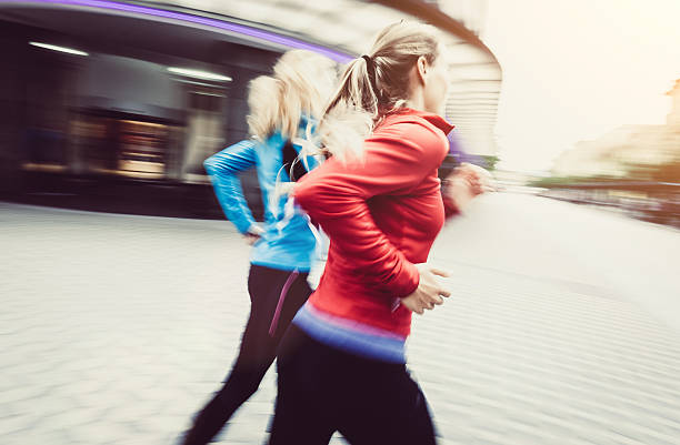 istock Two Young Women Running in the City 585057656