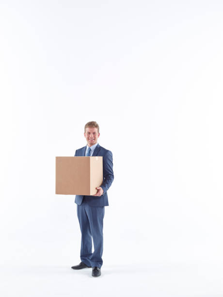 istock Business man carrying cardboard box 585058410