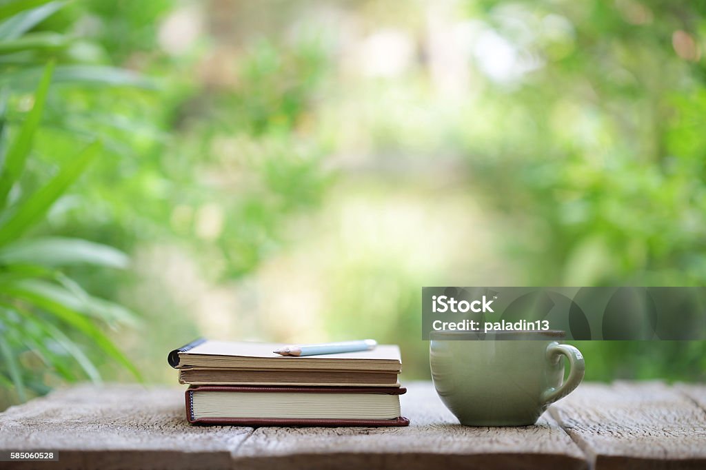 Notebook with pencil and cup on wooden table Book Stock Photo