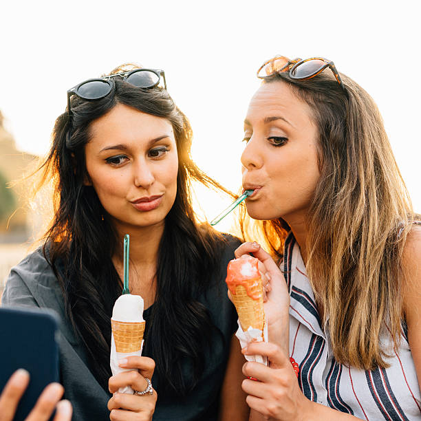 istock Young Friends Having Selfie While Eating Ice-Cream 585061274