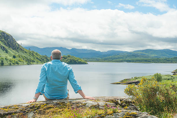 istock Single man relaxing on a rock in Kerry, Ireland. 585061382