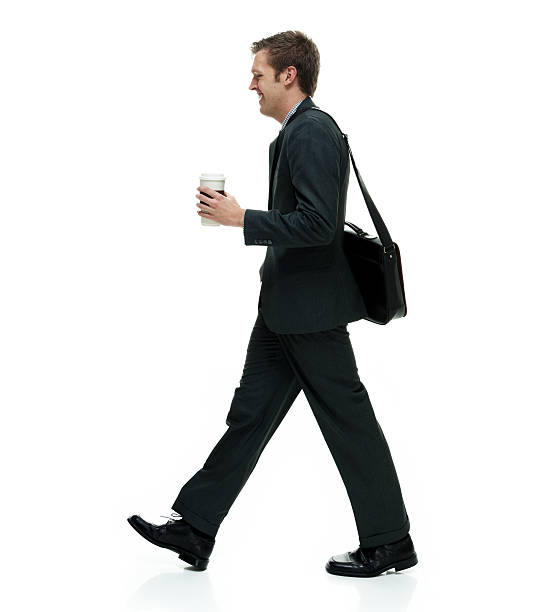 istock Smiling businessman walking 585062272