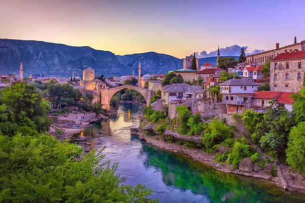 Mostar Bridge, Bosnia and Herzegovina The Neretva river winding through the old UNESCO listed, Mostar bridge in Bosnia and Herzegovina.   east photos stock pictures, royalty-free photos & images