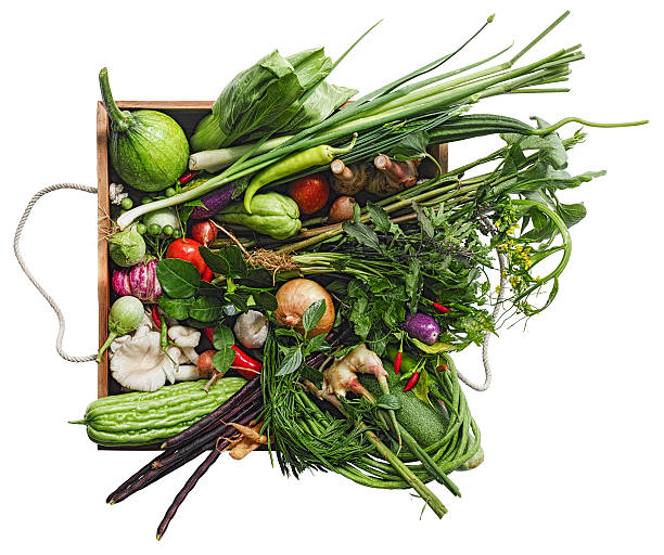 istock Traditional fresh Thai vegetables, herbs and spices in old crate. 585068102