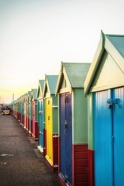 istock Row of colourful wooden beach huts 585068240