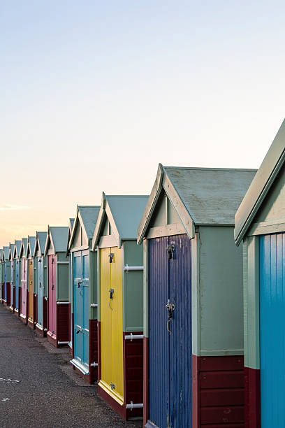 istock Row of colourful wooden beach huts 585068346