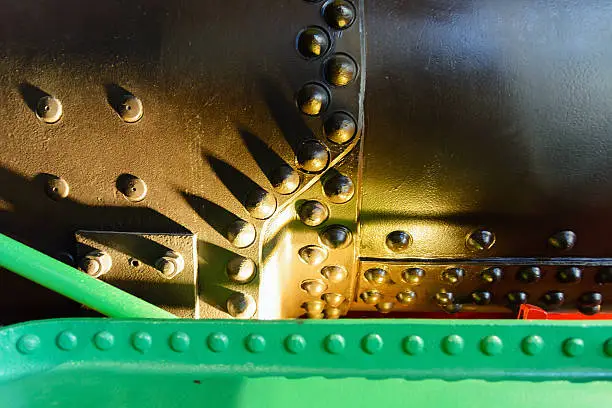 industrial background of metal plates fastened with rivets huge