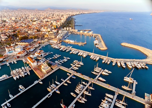 Aerial view of the beautiful Marina in Limassol city in Cyprus, the beach, boats, piers, villas, commercial area, old port (palio limani) and Molos. A very modern, high end and newly developed space where yachts are moored and it's perfect for a waterfront promenade.