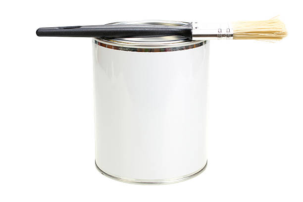 istock Paint can with blank white label and paintbrush isolated closeup 585069670