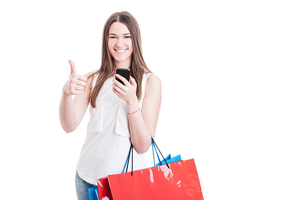 istock Modern shopping woman using mobile phone and thumb up 585070394