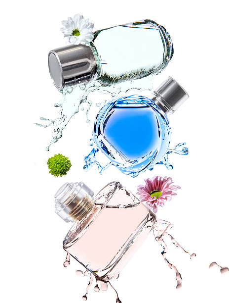 три бутылки различных цветов духов - perfume стоковые фото и изображения