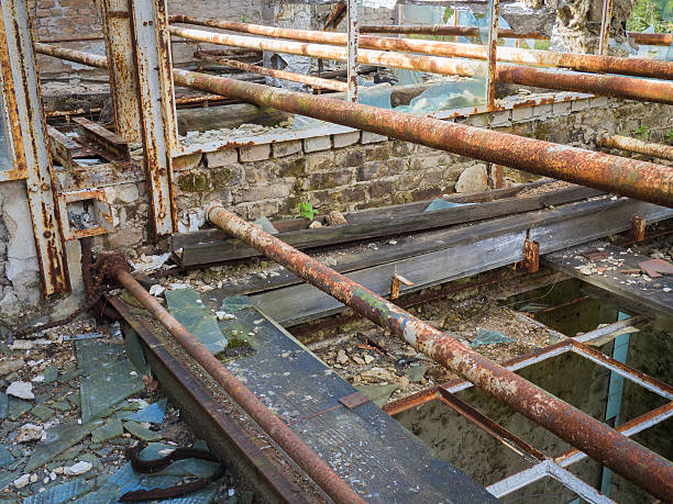 istock Old rusty tubes in an abandoneded place 585072190