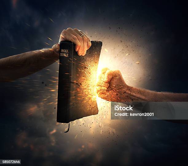 Punching The Bible Stock Photo - Download Image Now - Bible, Shield, Fire - Natural Phenomenon