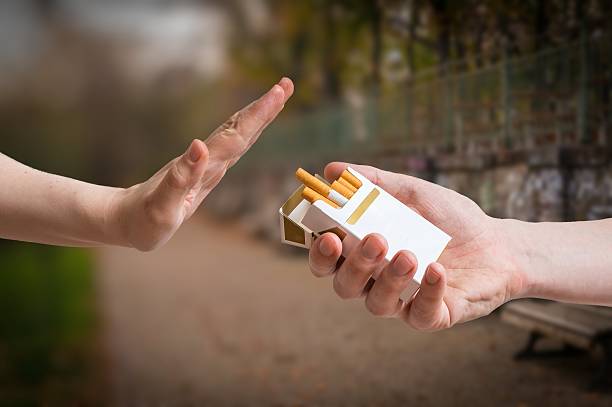 Quitting smoking concept. Hand is rejecting cigarette offer. stock photo