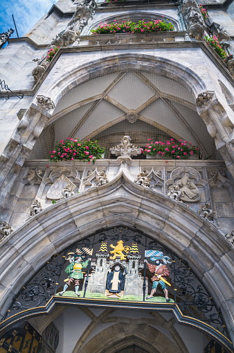 Munich, Germany - May 28, 2016: The Coat of arms of Munich over the doorway of the the Neues Rathaus (New Town Hall) at the Marienplatz Square in Munich, Bavaria, Germany features the Benedictine monk from which the city takes its name.