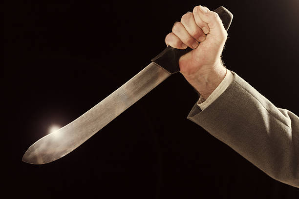 istock Businessman's hand holds knife, ready to stab 585075890