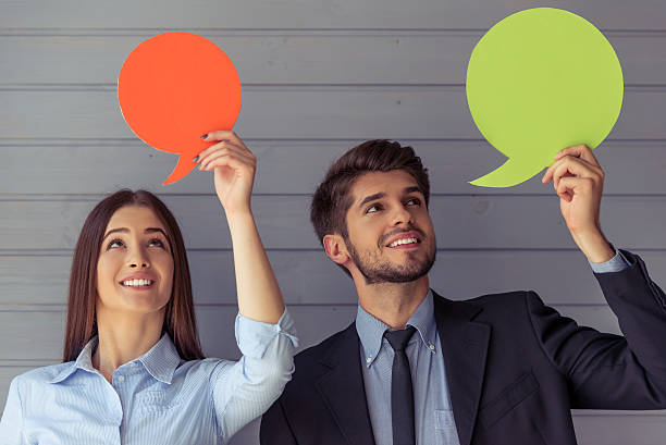 istock Beautiful business couple with speech bubbles 585077192
