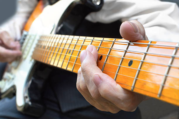 istock Elderly musician playing electric guitar. 585078844