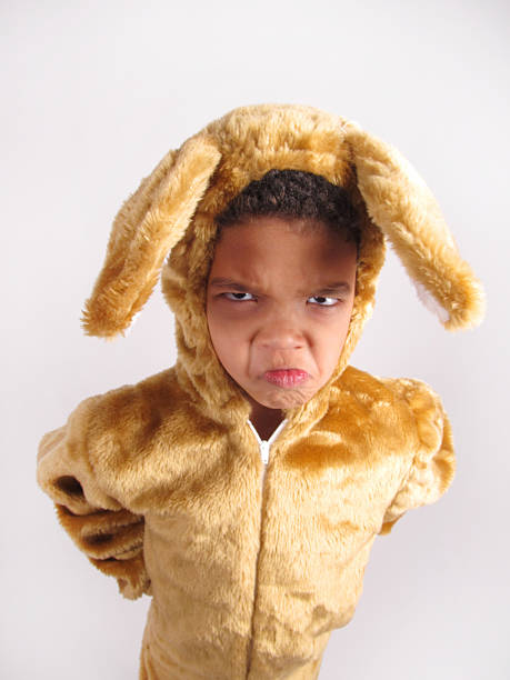 Cute toddler girl wearing a bunny ears at home during Easter celebration.