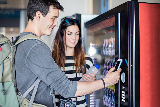 istock Young couple paying with mobile phone the soft drink 585080888