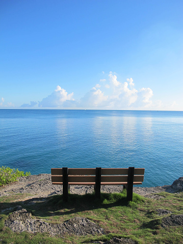 A bench sits empty at a lookout point, North Shore Road, Pembroke, Bermuda