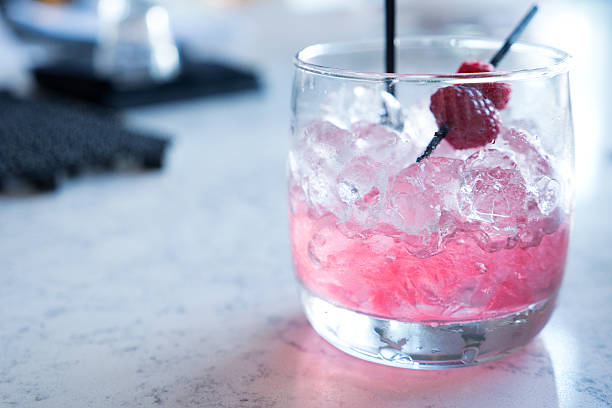 istock Empty Tumbler Glass with some Ice and Raspberry Left 585081384