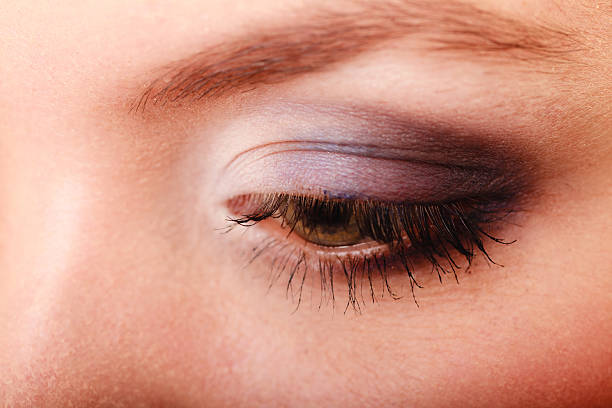 istock Closeup beautiful female eye with make-up visage. 585082898