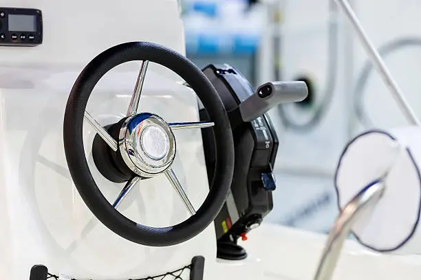 new powerful black-chrome steering wheel for boat;  note shallow depth of field