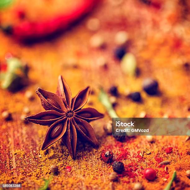 Variation Of Spices And Herbs On Wooden Background Stock Photo - Download Image Now - Backgrounds, Cardamom, Cayenne Powder