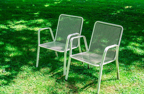 istock Green lawn with two chairs - life is good 585083296
