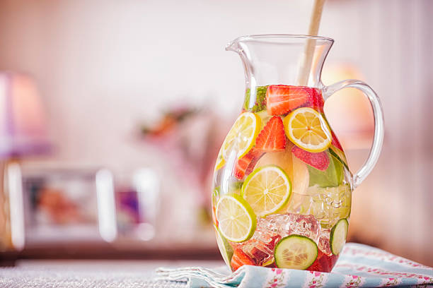 Infused Water with Fresh Strawberries, Lime, Lemon and Basil Infused water with fresh strawberries, lime, lemon and basil served in a glass. lime basil plant stock pictures, royalty-free photos & images