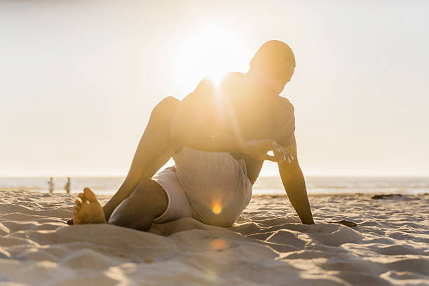 istock Man stretching at beach against sky on sunny day 585084398