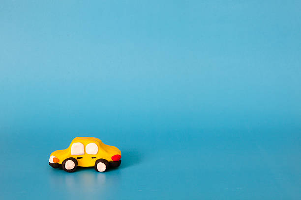 istock yellow car modeling clay on blue background 585087552
