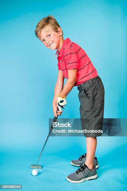 Six Year Old Junior Golfer Putting Stock Photo - Download Image Now - 6-7 Years, Activity, Boys