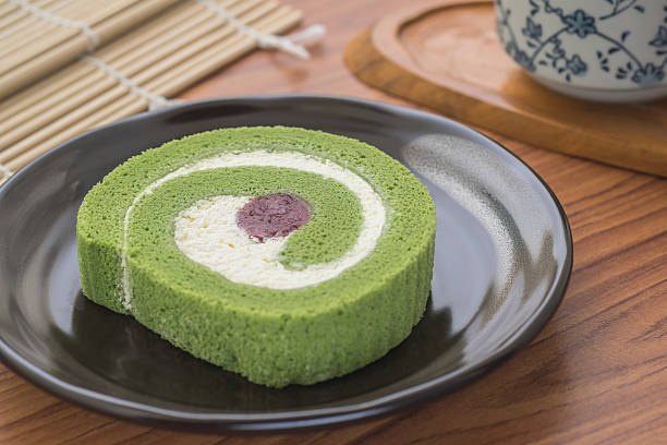 istock Green tea roll cake with red bean on plate 585088786
