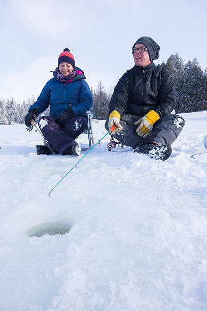 istock Couple ice fishing 585088980