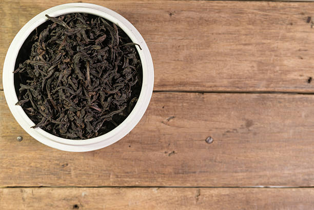 istock Dried Chinese tea on wooden table 585089098